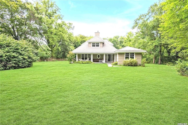1 Breeze Hill Rd, Northport, NY 11768 - rear view of house with a lawn and a chimney