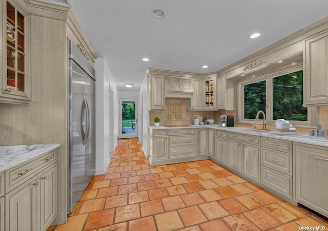 1 Breeze Hill Rd, Northport, NY 11768 - kitchen with light stone counters, stainless steel built in fridge, cream cabinetry, and glass insert cabinets
