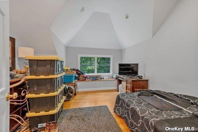1 Breeze Hill Rd, Northport, NY 11768 - bedroom with vaulted ceiling and wood finished floors