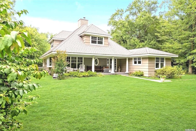 1 Breeze Hill Rd, Northport, NY 11768 - view of front facade with a chimney, roof with shingles, covered porch, and a front yard