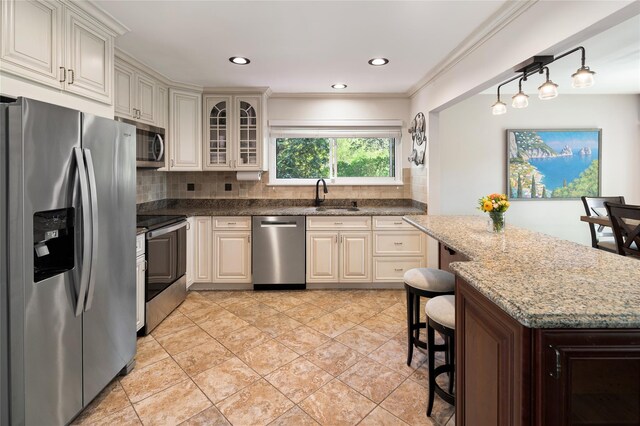 kitchen with a sink, dark stone countertops, stainless steel appliances, backsplash, and glass insert cabinets