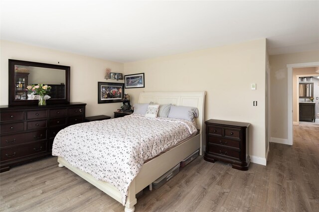 bedroom featuring baseboards and light wood-style floors