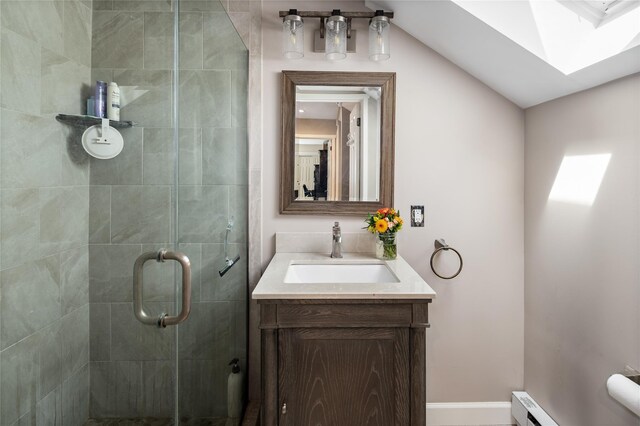 bathroom with a skylight, a shower stall, baseboard heating, and vanity
