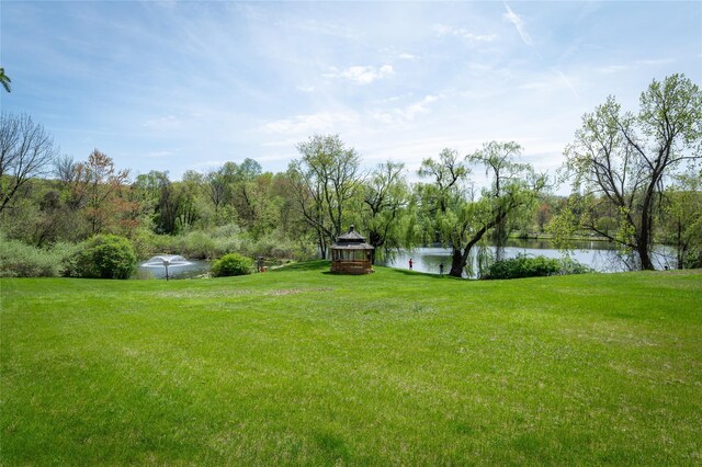 view of yard with a gazebo and a water view