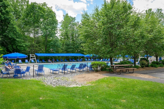 community pool featuring a lawn