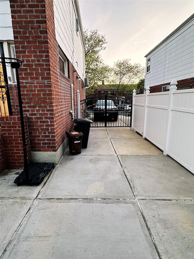 exterior space with fence, a gate, and driveway
