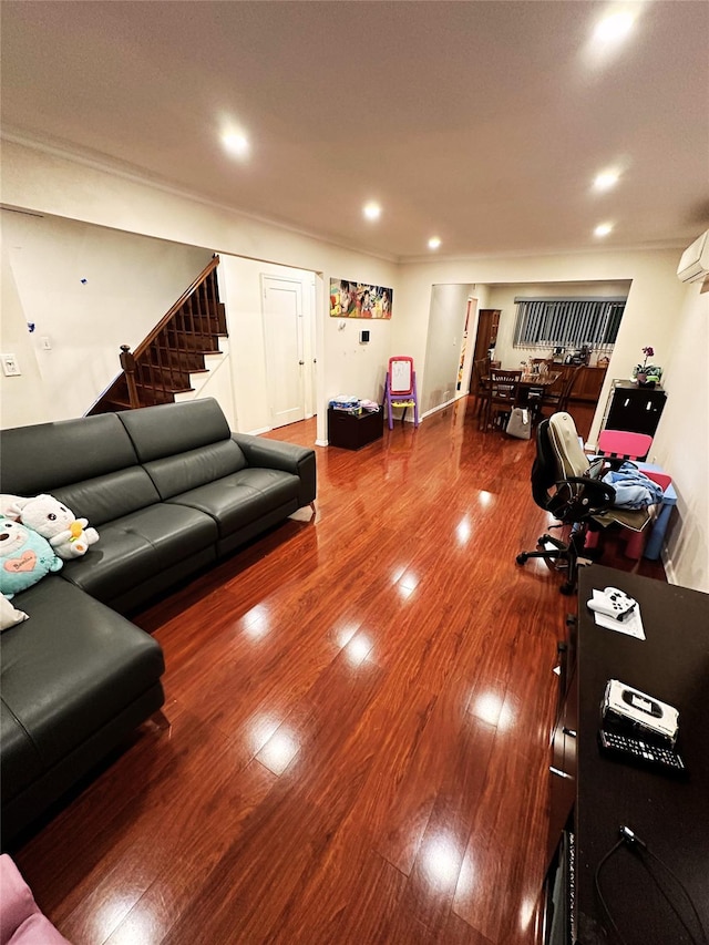 living area with recessed lighting, stairs, and wood finished floors