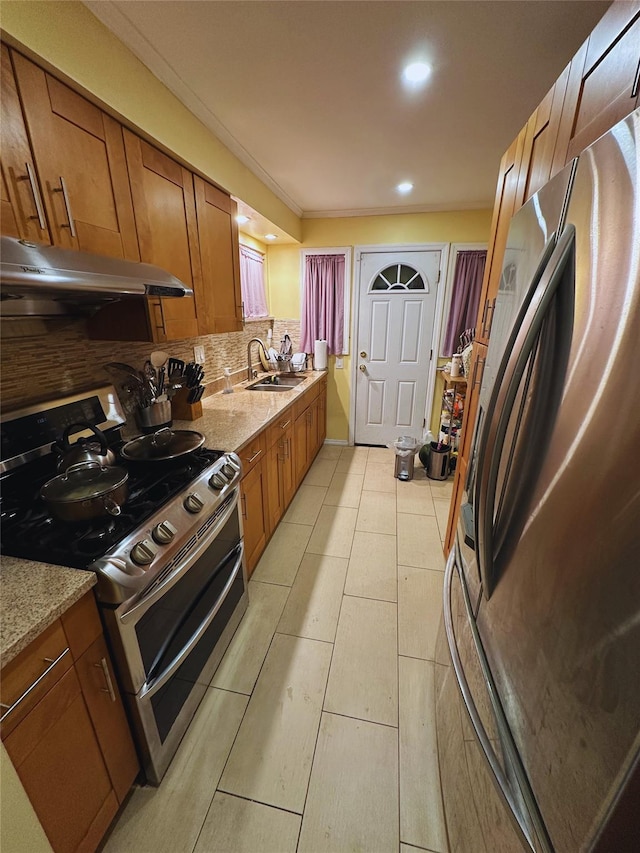 kitchen featuring decorative backsplash, brown cabinetry, appliances with stainless steel finishes, a sink, and under cabinet range hood