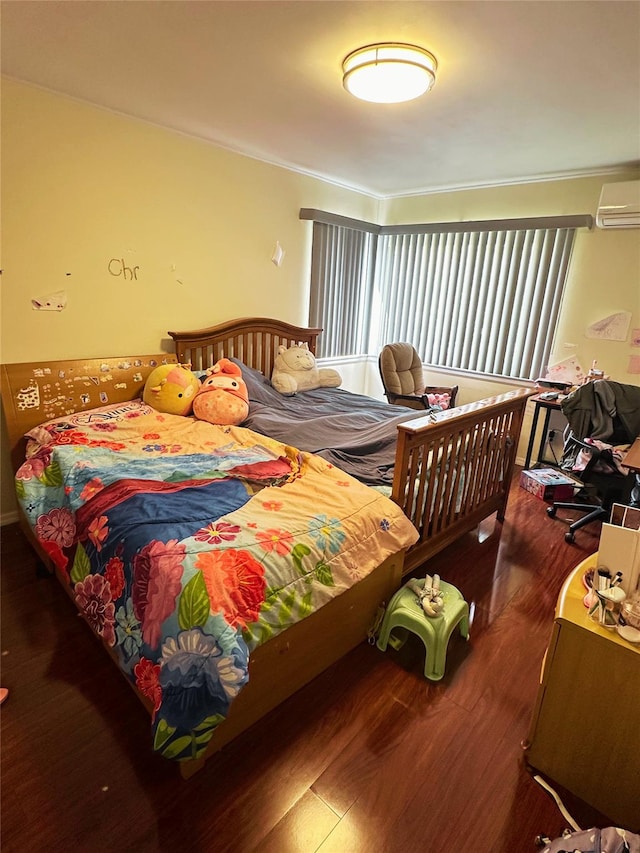 bedroom featuring crown molding, an AC wall unit, and wood finished floors