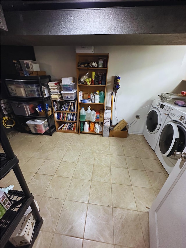 laundry area with laundry area, tile patterned floors, and washing machine and clothes dryer