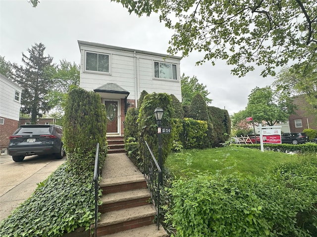 6759 197th St, Fresh Meadows, NY 11365 - view of front facade featuring brick siding and driveway