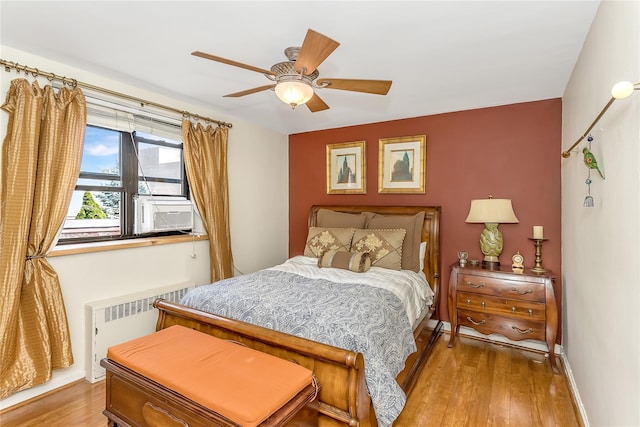 36-07 171st St Unit 36, Flushing, NY 11358 - bedroom featuring wood finished floors, baseboards, ceiling fan, and radiator heating unit