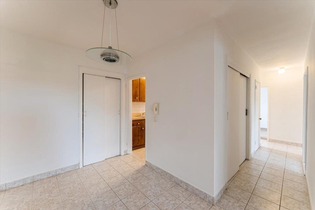 142-20 26th Ave Unit 5H, Flushing, NY 11354 - corridor featuring light tile patterned flooring and baseboards