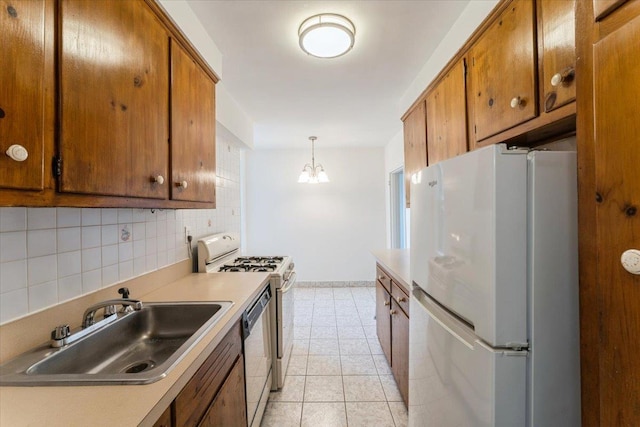 142-20 26th Ave Unit 5H, Flushing, NY 11354 - kitchen with white appliances, a sink, brown cabinetry, backsplash, and a chandelier