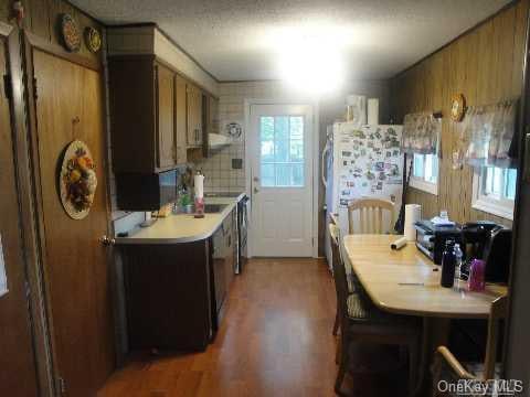 kitchen with light countertops, brown cabinets, and light wood-style floors
