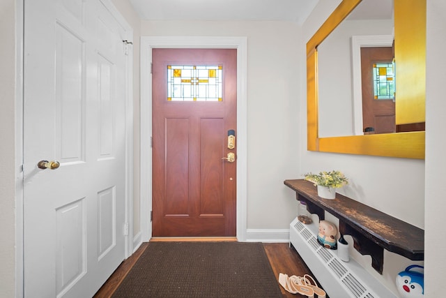 19 Donald St, East Williston, NY 11596 - entrance foyer featuring dark wood-style floors, a baseboard heating unit, and baseboards