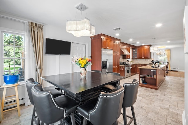 19 Donald St, East Williston, NY 11596 - dining area featuring a chandelier, baseboard heating, healthy amount of natural light, and recessed lighting