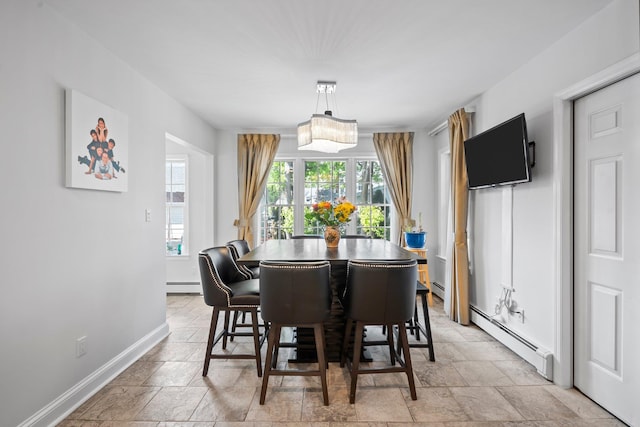 19 Donald St, East Williston, NY 11596 - dining area featuring stone tile flooring, a baseboard heating unit, and baseboards