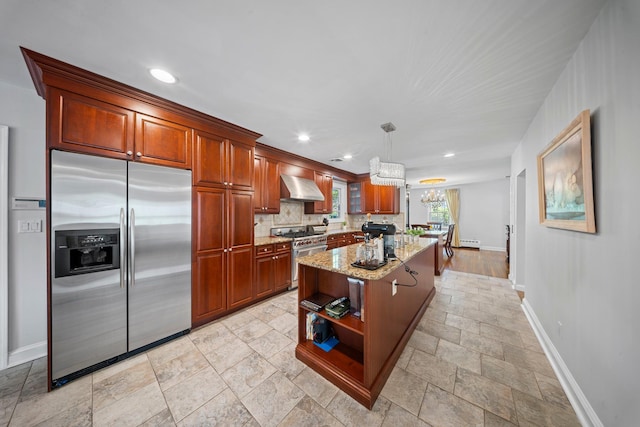 19 Donald St, East Williston, NY 11596 - kitchen featuring appliances with stainless steel finishes, baseboards, stone tile floors, wall chimney range hood, and light stone countertops
