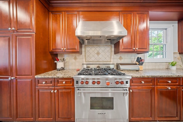 19 Donald St, East Williston, NY 11596 - kitchen with luxury range, range hood, reddish brown cabinets, and backsplash