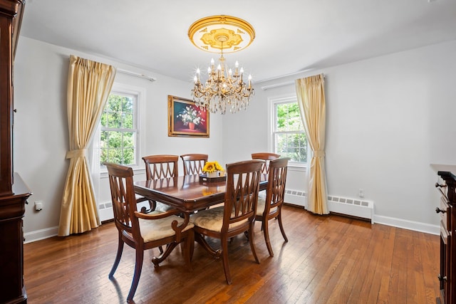 19 Donald St, East Williston, NY 11596 - dining room with a baseboard radiator, hardwood / wood-style flooring, a chandelier, and baseboards