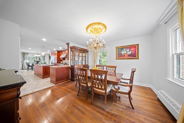 19 Donald St, East Williston, NY 11596 - dining area with a chandelier, a baseboard radiator, healthy amount of natural light, light wood-style floors, and recessed lighting