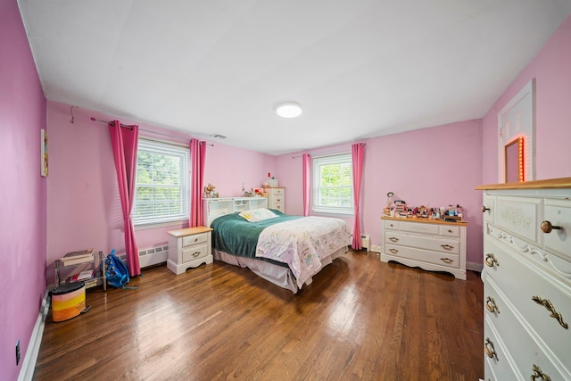 19 Donald St, East Williston, NY 11596 - bedroom with wood finished floors, a baseboard heating unit, and baseboards