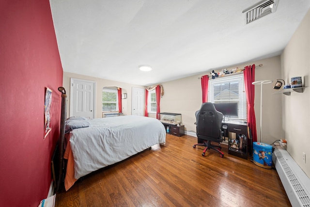 19 Donald St, East Williston, NY 11596 - bedroom with a baseboard heating unit, wood finished floors, and multiple windows