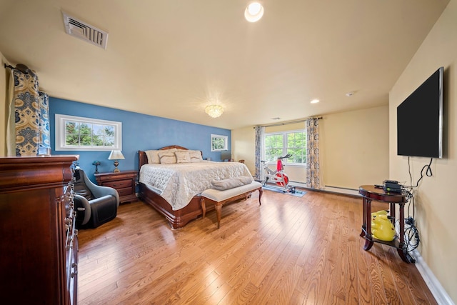 19 Donald St, East Williston, NY 11596 - bedroom with hardwood / wood-style flooring, a baseboard heating unit, baseboards, and recessed lighting