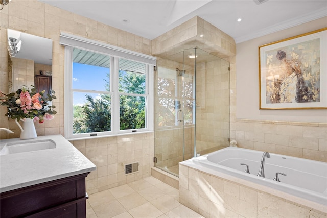 full bath with tile walls, vanity, visible vents, a shower stall, and a garden tub