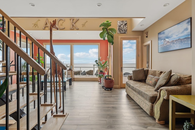 516 Asharoken Ave, Northport, NY 11768 - living room with wood finished floors, stairs, a water view, healthy amount of natural light, and recessed lighting