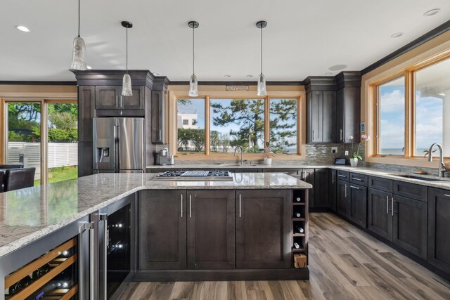 516 Asharoken Ave, Northport, NY 11768 - kitchen with a sink, stainless steel appliances, wine cooler, crown molding, and recessed lighting