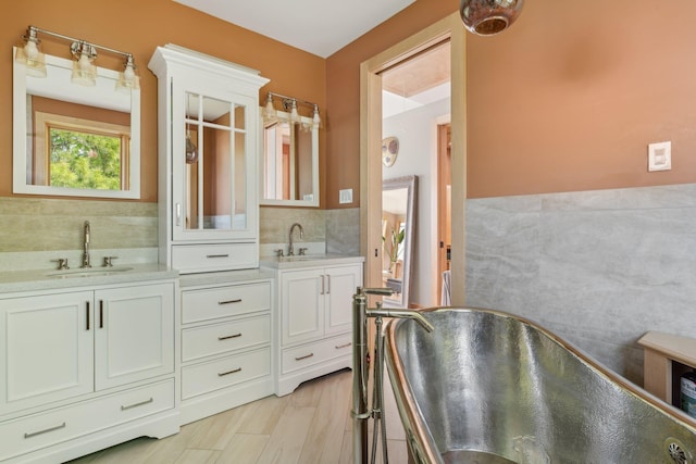 516 Asharoken Ave, Northport, NY 11768 - bathroom with double vanity, a freestanding bath, and decorative backsplash