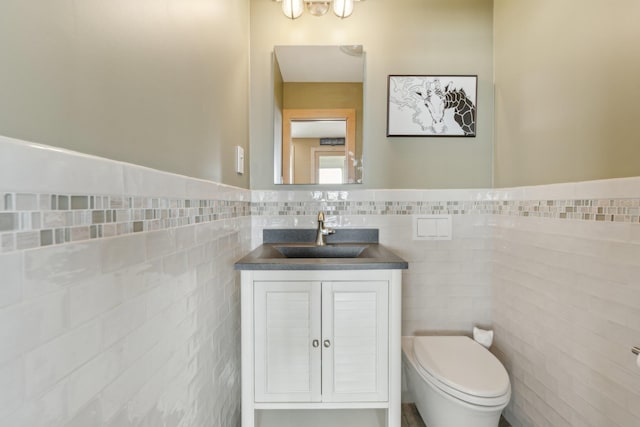 516 Asharoken Ave, Northport, NY 11768 - half bath featuring tile walls, vanity, toilet, and a wainscoted wall