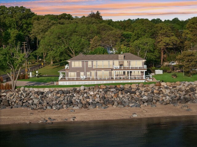 516 Asharoken Ave, Northport, NY 11768 - aerial view of property and surrounding area featuring a nearby body of water and a heavily wooded area