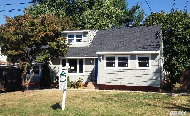 bungalow-style house with entry steps, a shingled roof, and a front yard