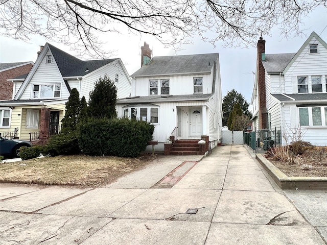 view of front of house with fence and a chimney
