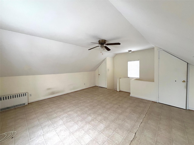 bonus room featuring baseboards, ceiling fan, vaulted ceiling, and radiator heating unit