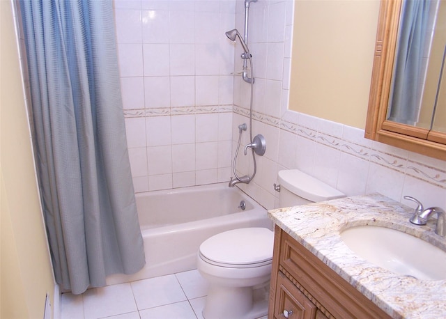 bathroom with tile patterned flooring, vanity, toilet, tile walls, and shower / bath combo