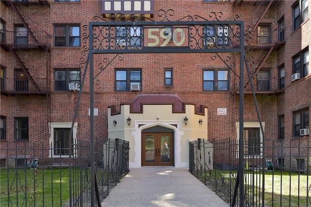 view of building exterior with cooling unit and fence