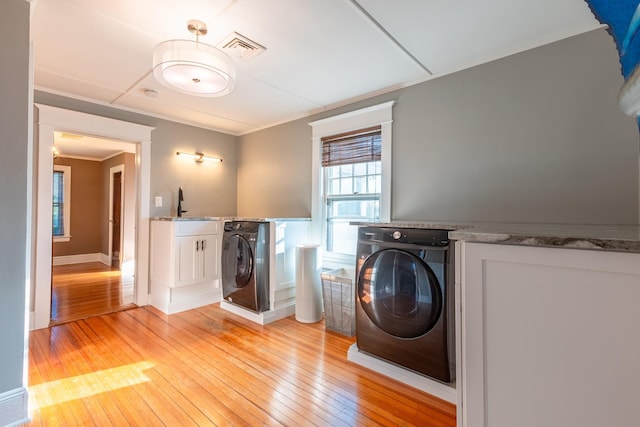 44 S Montgomery Ave, Bay Shore, NY 11706 - laundry area featuring ornamental molding, light wood-style floors, and a sink