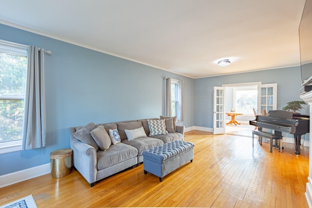 44 S Montgomery Ave, Bay Shore, NY 11706 - living room featuring light wood-type flooring, baseboards, crown molding, and french doors