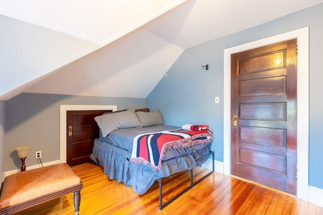 44 S Montgomery Ave, Bay Shore, NY 11706 - bedroom featuring light wood finished floors, lofted ceiling, and baseboards