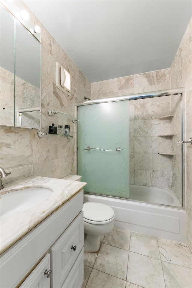 25-40 Shore Blvd Unit 6M, Astoria, NY 11102 - bathroom with vanity, marble finish floor, toilet, tile walls, and shower / tub combination