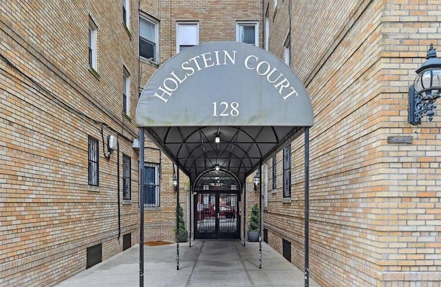 128 W 138th St Unit 5F, New York Manhattan, NY 10030 - view of exterior entry with brick siding and crawl space