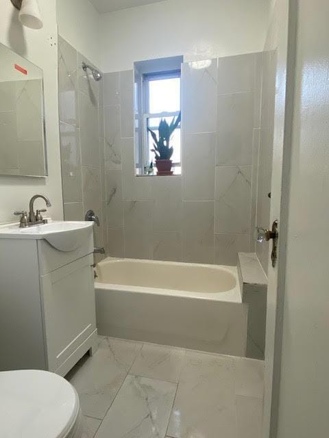 128 W 138th St Unit 5F, New York Manhattan, NY 10030 - bathroom with toilet, marble finish floor, vanity, and bathtub / shower combination