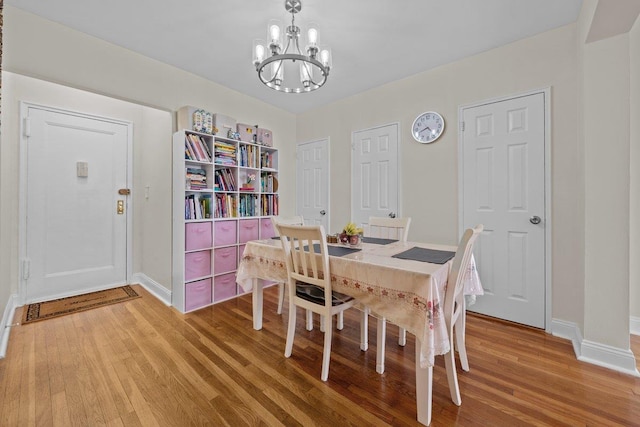 19 Abeel St Unit 6E, Yonkers, NY 10705 - dining area featuring baseboards, light wood-style flooring, and a notable chandelier