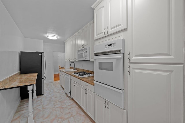 19 Abeel St Unit 6E, Yonkers, NY 10705 - kitchen featuring white cabinets, a sink, white appliances, baseboards, and a warming drawer