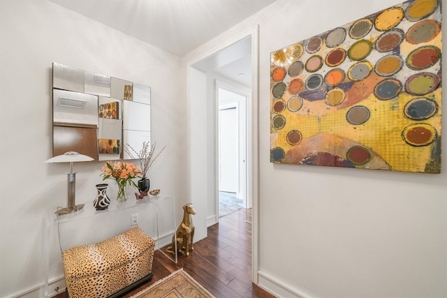 hallway featuring baseboards and hardwood / wood-style floors