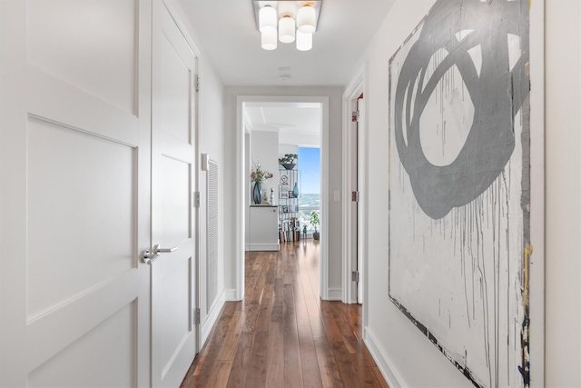 hall featuring baseboards and dark wood finished floors